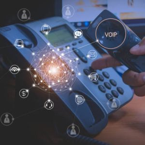 Hand of man using ip phone with flying icon of voip services and people connection, voip and telecommunication concept
